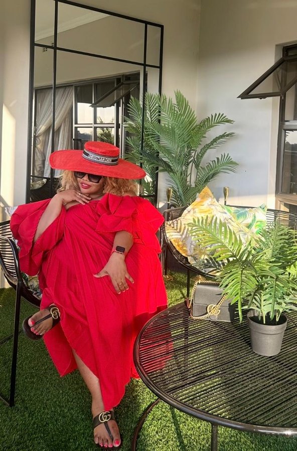 Alice celebrating in a vibrant red outfit and red sunhat